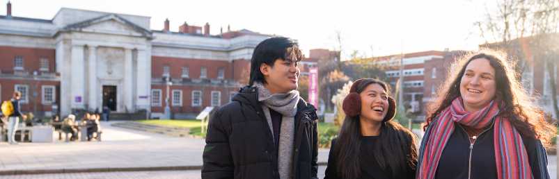 Three Manchester students outside Sam Adams Building