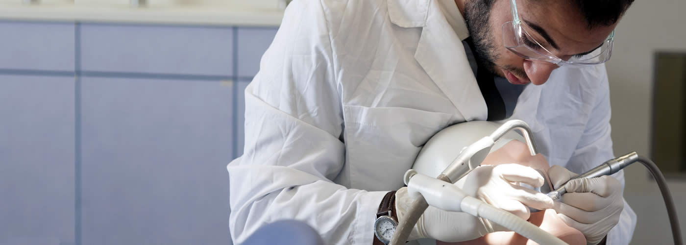 Dentistry student practicing on a dummy.