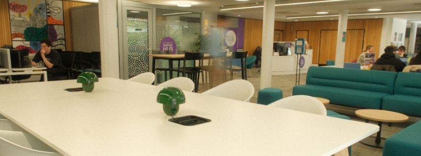 Photo of the SALC hub with table and students. 