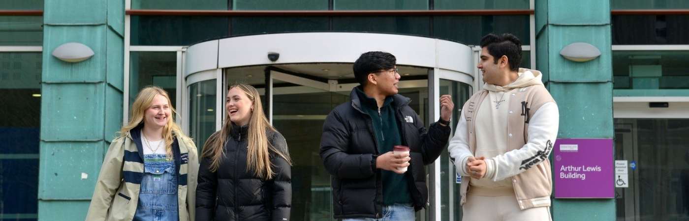Four students chatting on University campus
